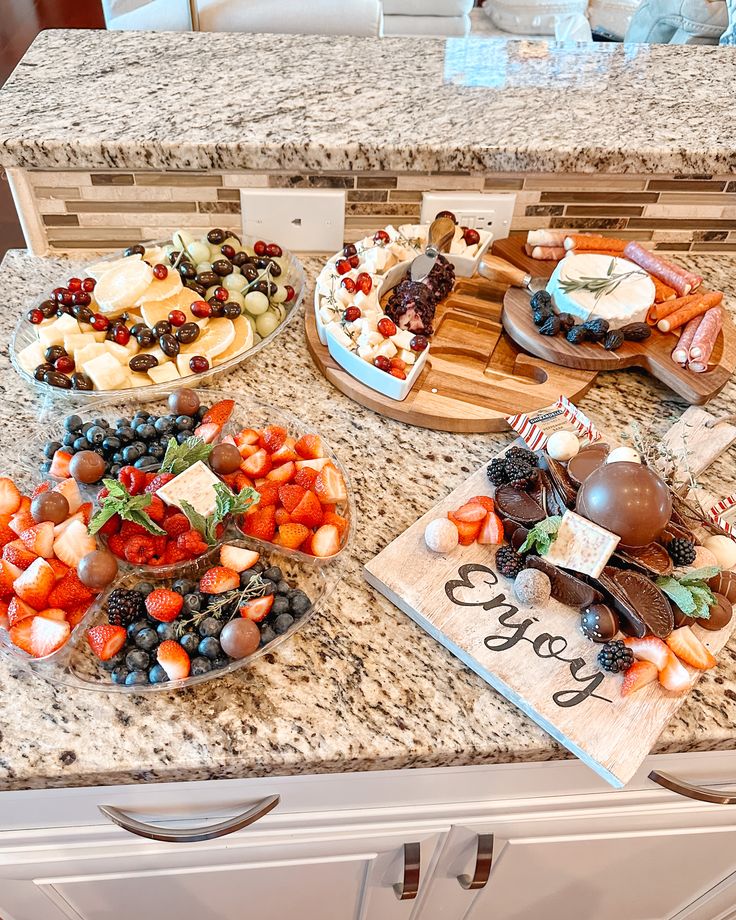 a kitchen counter topped with plates and bowls filled with food