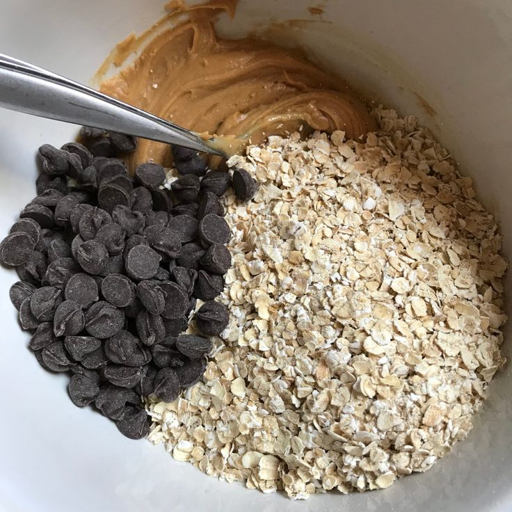 a bowl filled with oatmeal, chocolate chips and peanut butter