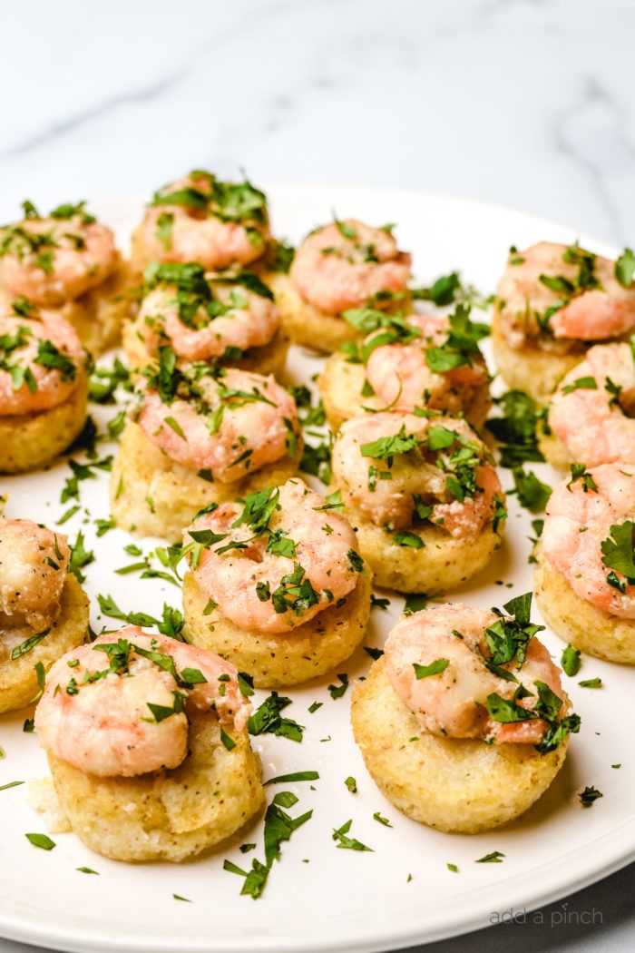 small appetizers on a plate with parsley sprinkled around them, ready to be eaten