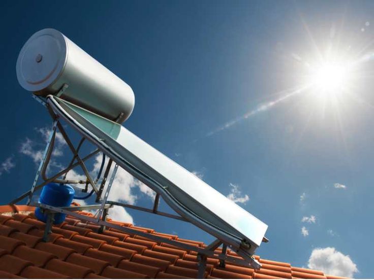 a satellite dish on top of a roof with the sun in the background