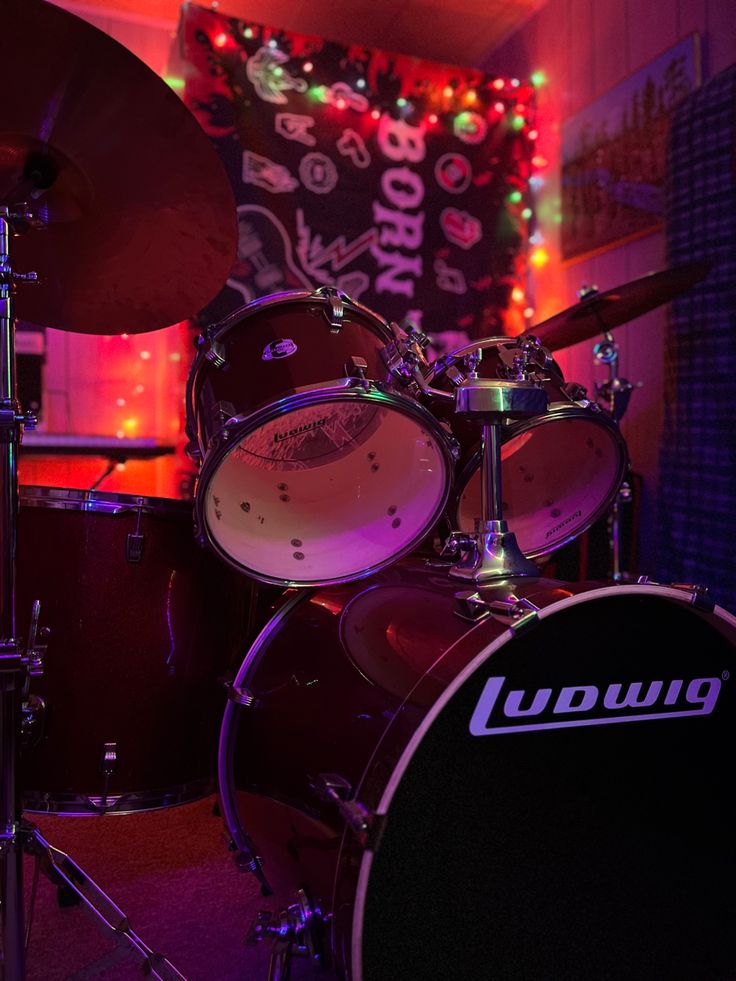 a drum set is lit up with christmas lights