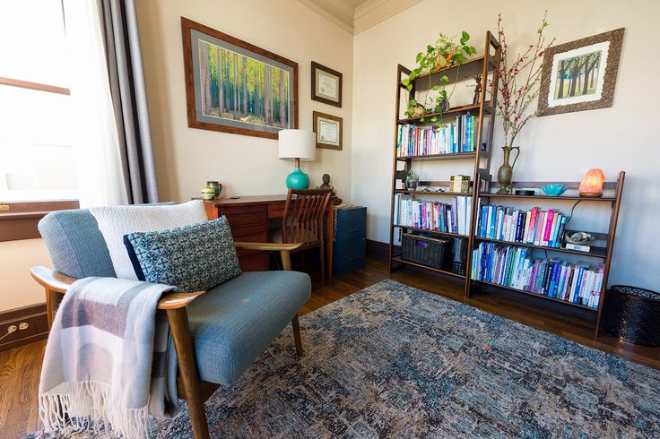 a living room filled with furniture and bookshelves