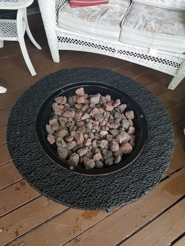 a fire pit sitting on top of a wooden floor