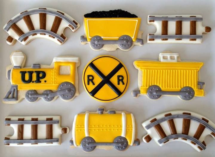 train cookies are arranged in the shape of railroad tracks and trains on top of each other