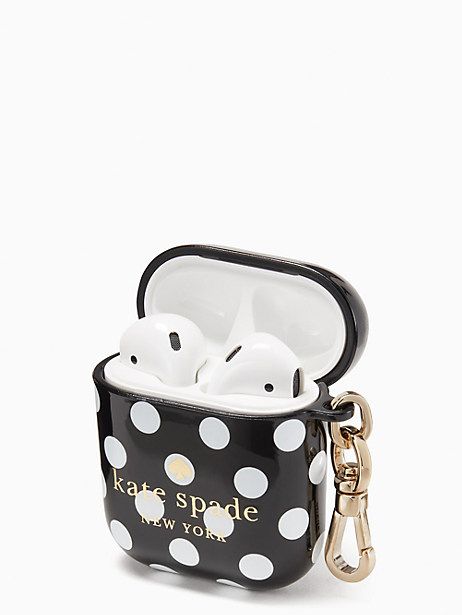 an apple airpods case with white polka dots on it and a gold keychain