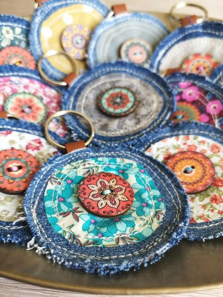 a bunch of different colored plates on a plate with some keychains attached to them