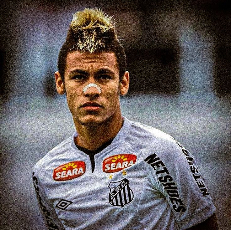 a close up of a soccer player with a nose patch on his face and short hair