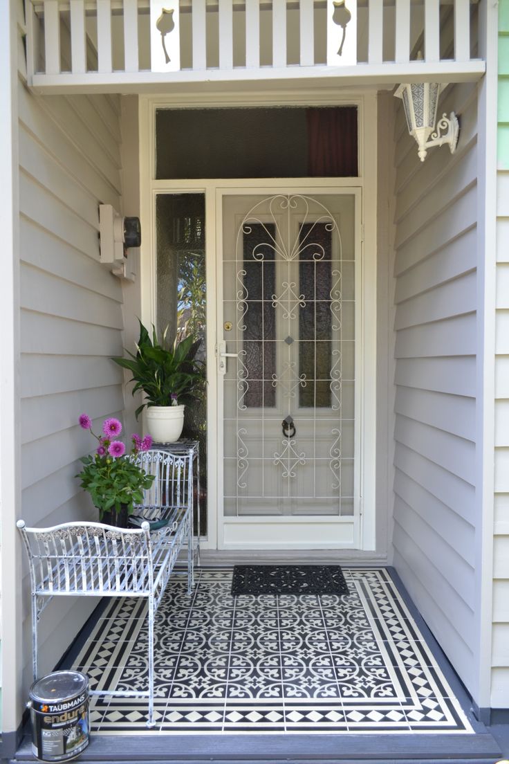 a white front door sitting next to a potted plant