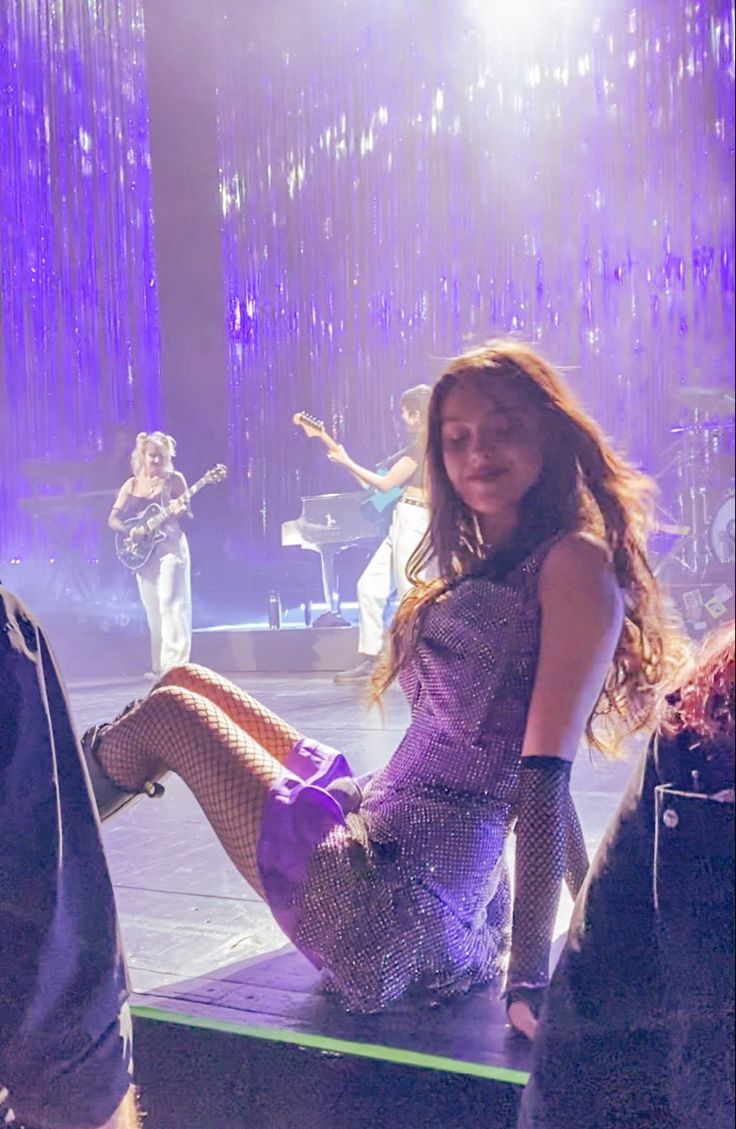 a woman sitting on top of a stage