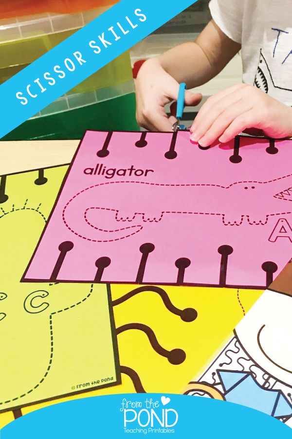 a young child is working on some sort of activity with scissors and writing paper that says alligator