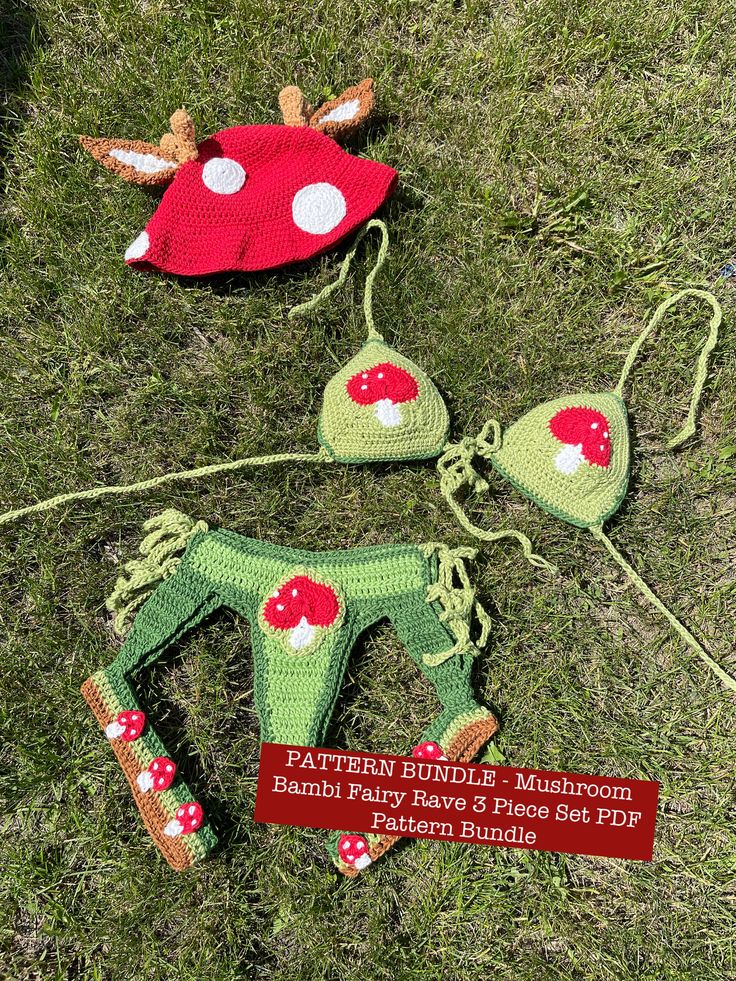 three crocheted items are laying on the grass