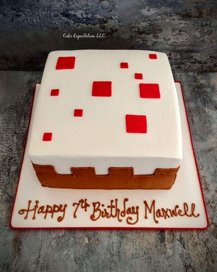 a birthday cake for a man with red and white squares on the frosted surface