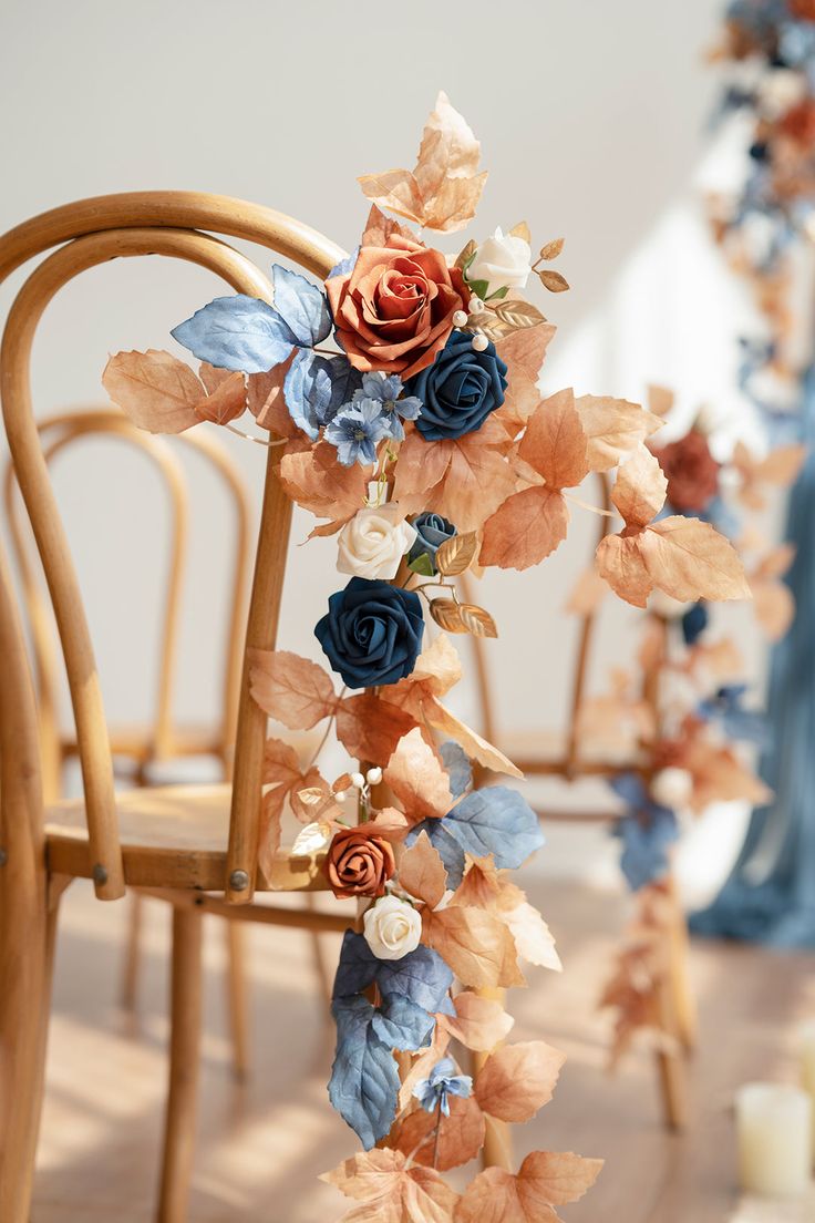 an arrangement of flowers and leaves on a chair for a wedding or special event decoration