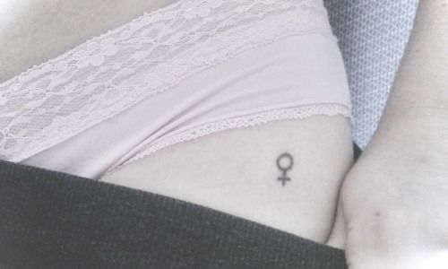 a woman's stomach with a small tattoo on it