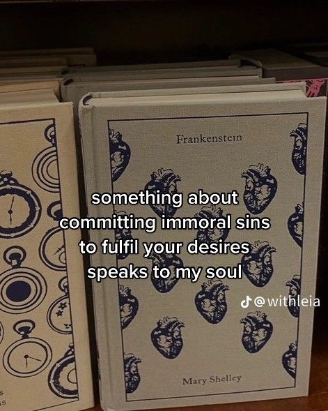 two books sitting next to each other on top of a wooden table in front of a book shelf