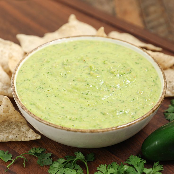 a bowl of guacamole surrounded by tortilla chips