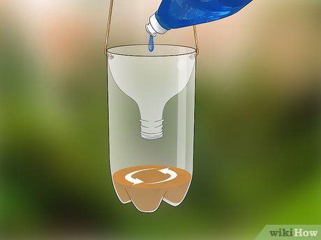 a blue bottle being poured into a glass filled with liquid from a faucet