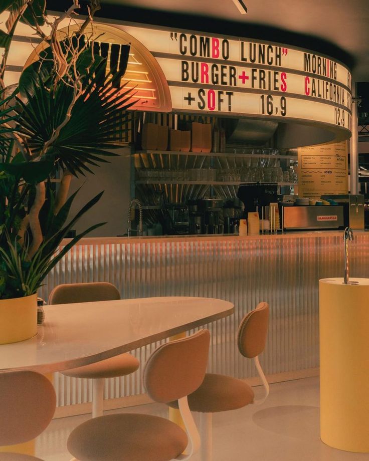 the interior of a fast food restaurant with tables and chairs