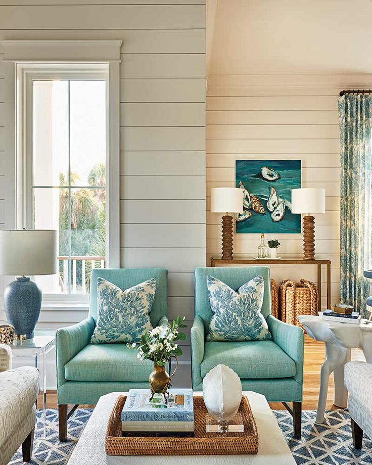 a living room with two couches, chairs and a coffee table in front of a window