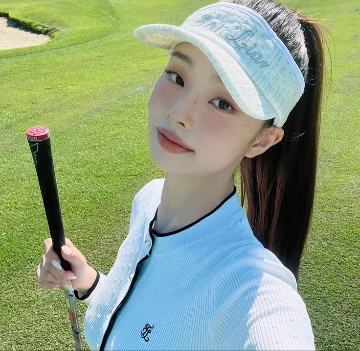 a woman holding a golf club in her hand