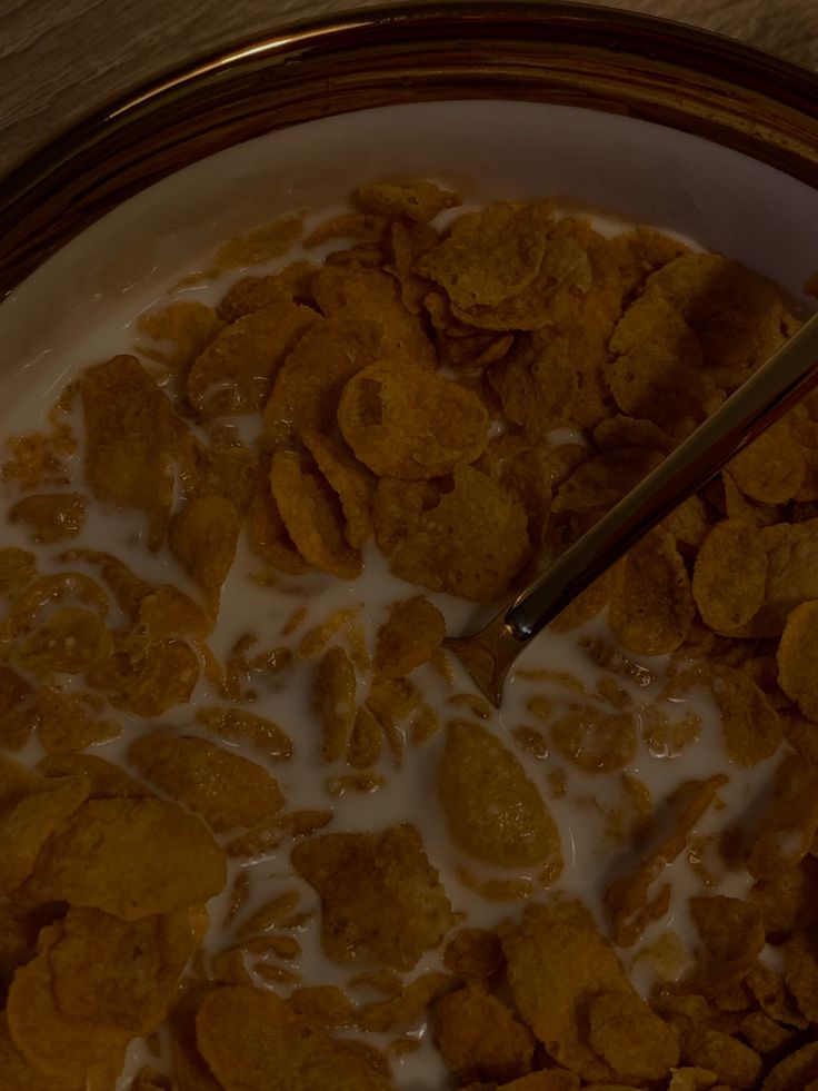 a bowl filled with cereal and milk on top of a table