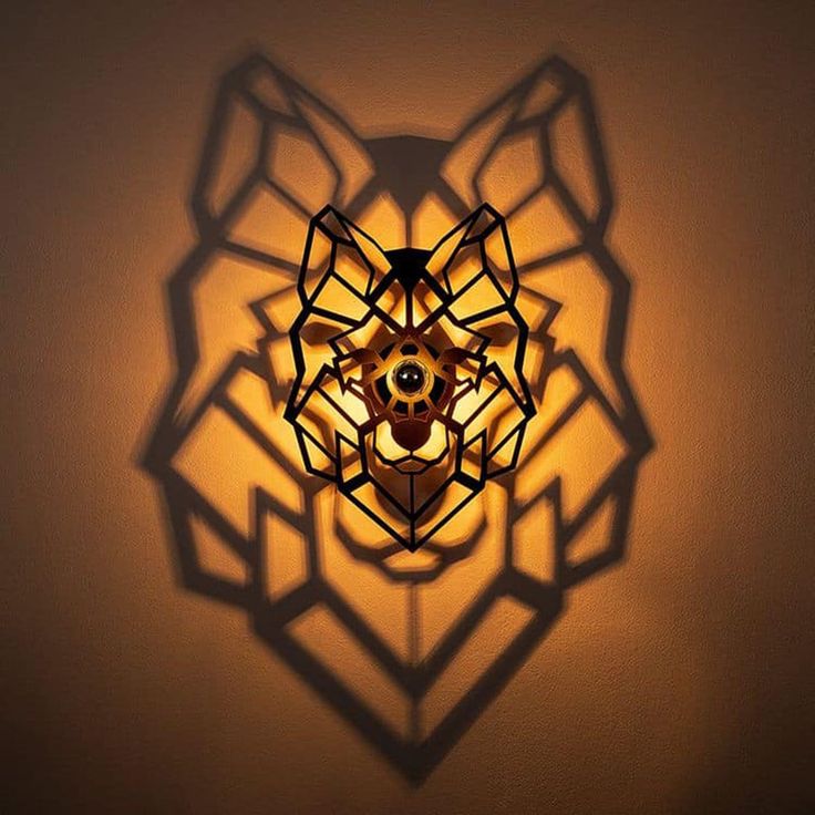 a lamp that is on the wall next to a light fixture with an intricate design