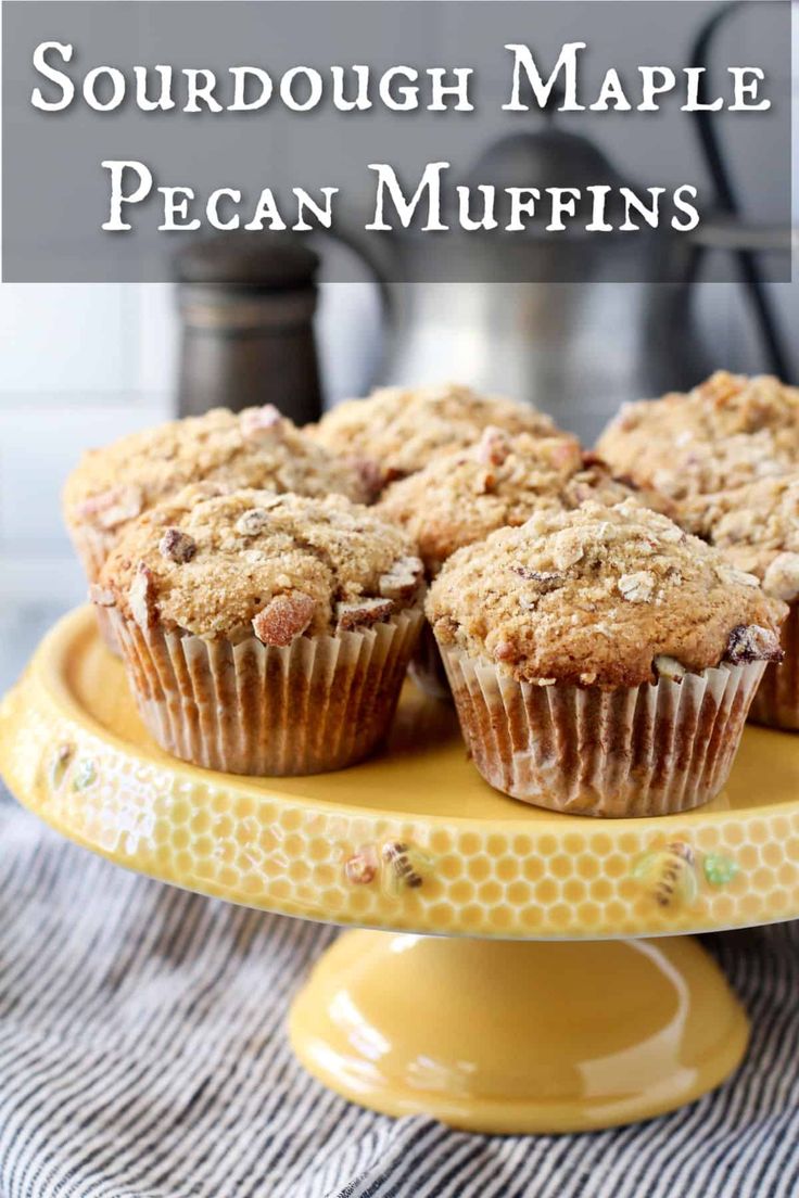 a yellow plate topped with muffins on top of a table