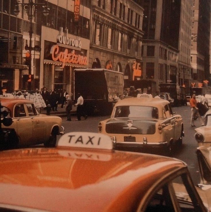 an old photo of taxis and cabs on a busy street in new york city