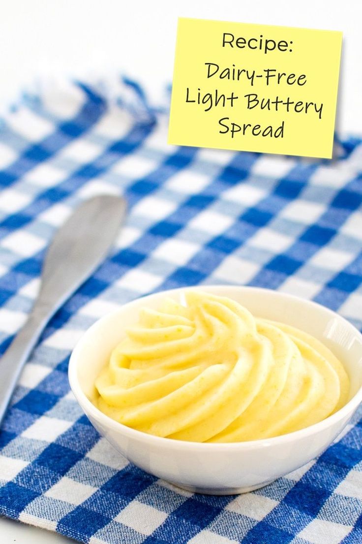 a white bowl filled with butter on top of a blue and white checkered table cloth