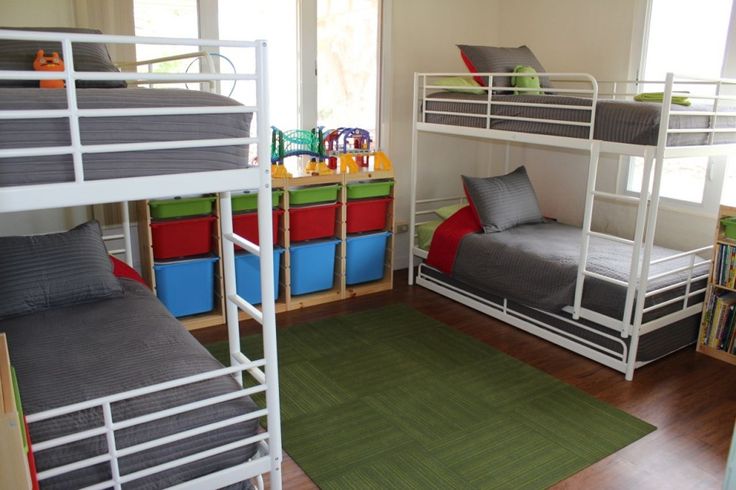 a room with bunk beds and green rugs