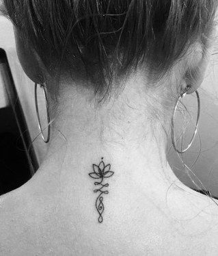 a woman with a tattoo on her back neck