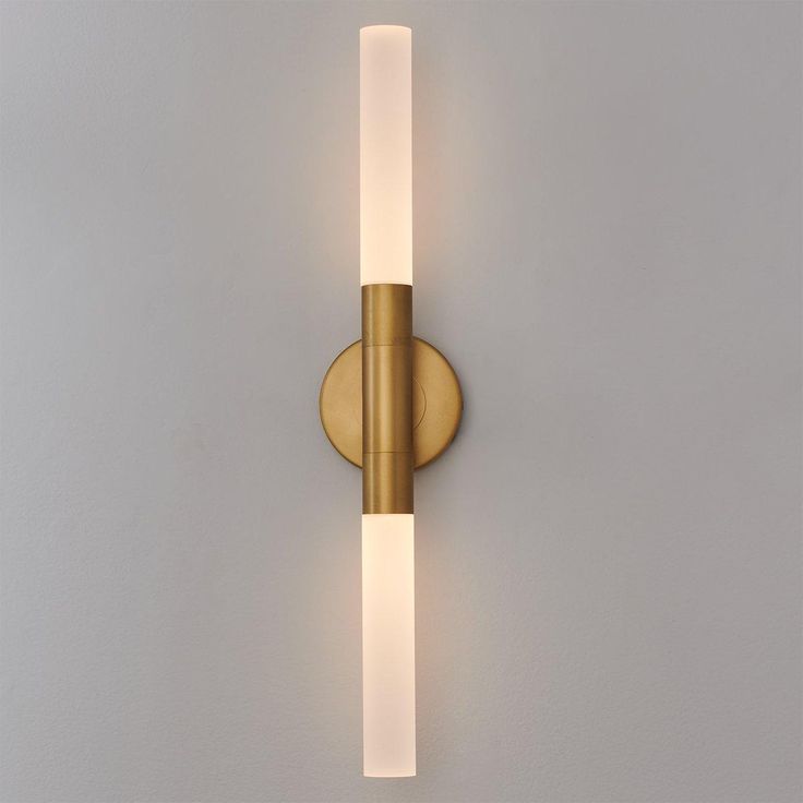 a wall mounted light on the side of a wall with a white glass strip in front of it