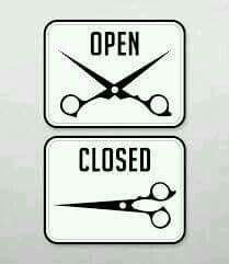 two white signs with scissors on them that say open and closed in red text below