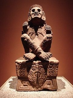 a stone statue sitting on top of a table