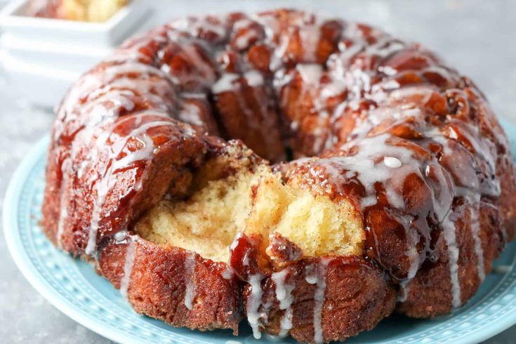 a bundt cake with icing on a blue plate