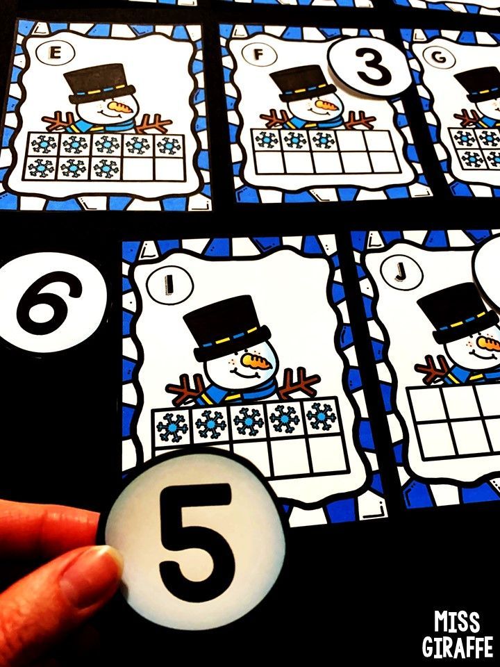 a hand holding a number five game with the numbers in front of it and six on each side