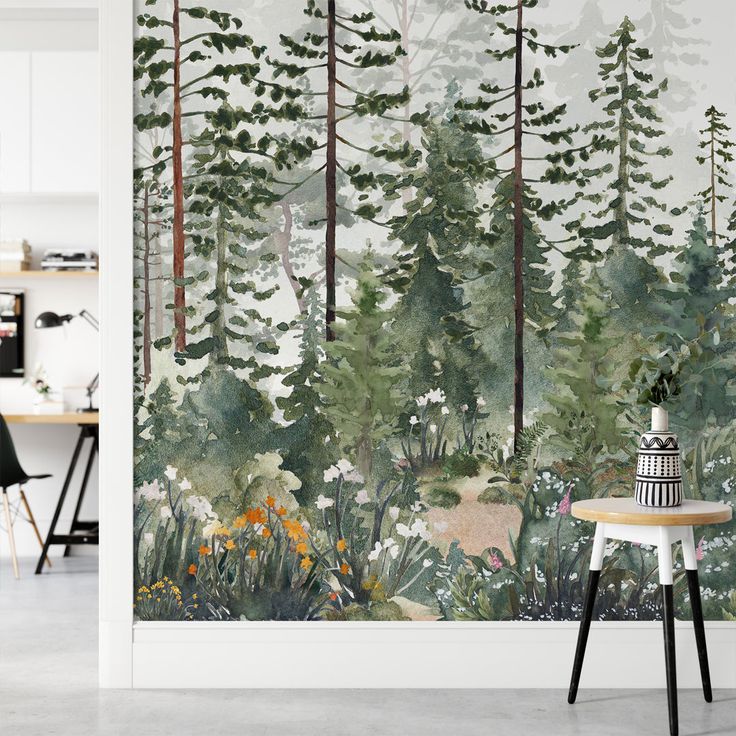 a wall mural with trees and flowers in the foreground, along with a table on the other side