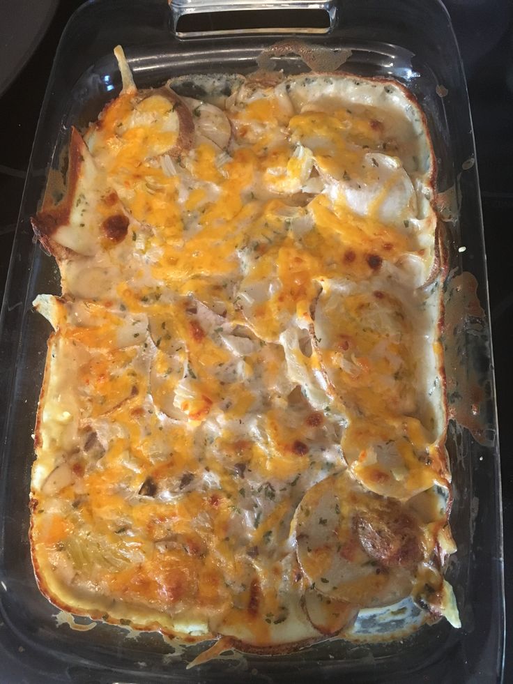 a casserole dish with cheese and mushrooms in it