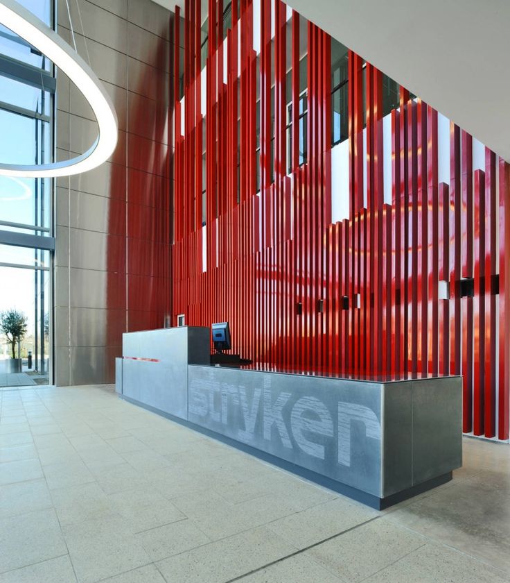 an office lobby with red and grey walls