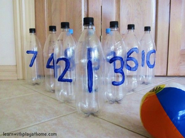 there are seven water bottles with numbers on them and an inflatable beach ball