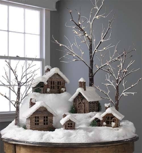 a christmas scene with snow covered houses and trees