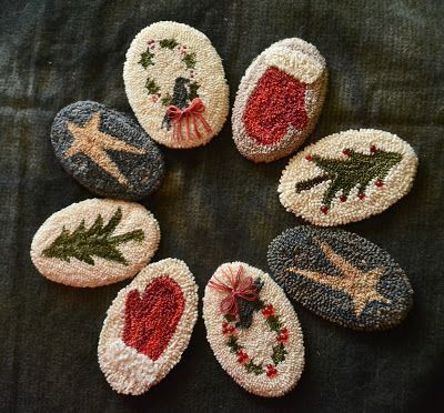 six hand embroidered christmas ornaments arranged in a circle on a black cloth surface with red, green and white trim