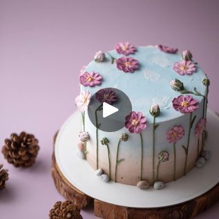 a cake decorated with flowers and pine cones