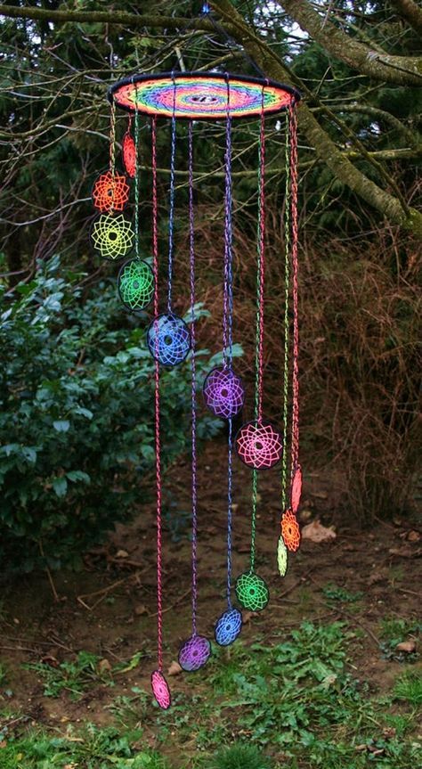 a multicolored wind chime hanging from a tree