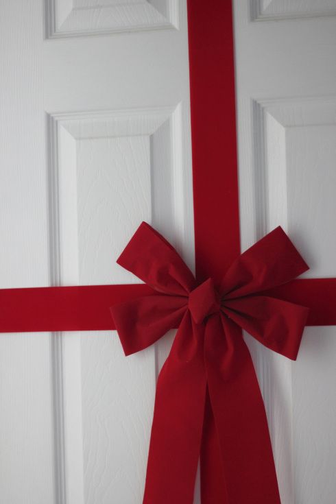 a red bow tied on the front door