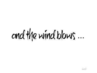 the words and the wind blows written in black ink