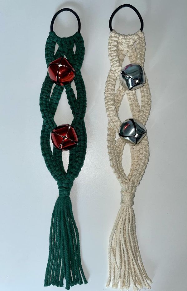 two pieces of rope with bells attached to them