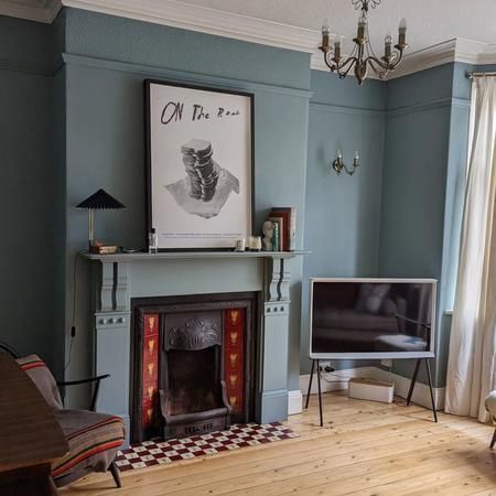 a living room filled with furniture and a fire place in front of a tv mounted on a wall