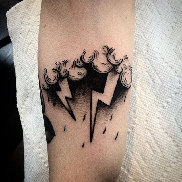 a black and white photo of a lightning tattoo on the arm