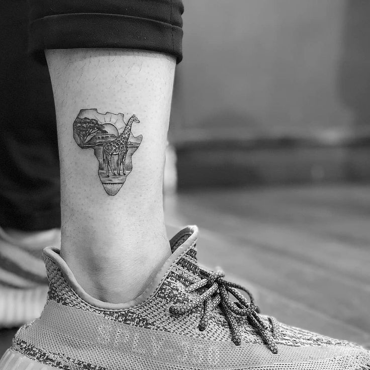 a small tattoo on the ankle of a woman's foot, depicting a cow skull